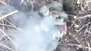 A Ukrainian paratrooper hits a Russian soldier who was trying to throw a grenade
