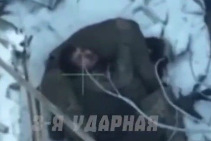 Colombian mercenary dies embracing his dead comrade.