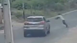 Man Jumps Under Moving Car And Gets Ragdolled