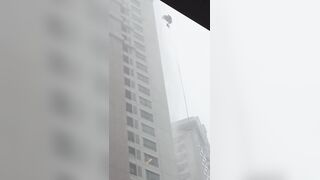 Window Washer, Still Attached to His Safety Harness, Slams Against High-rise