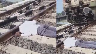 Decapitated Man Lying On Tracks As Trains Pass By