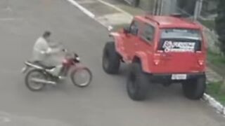 Dumb Biker Plows Into The Jeep, Nearly Dies