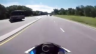 Biker slides under a turning truck