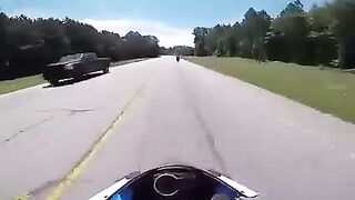 Biker slides under a turning truck