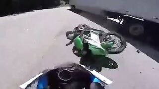 Biker slides under a turning truck