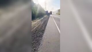 Dead corpse of pedoruzzian truck driver swaying from a cabin on occupied territories