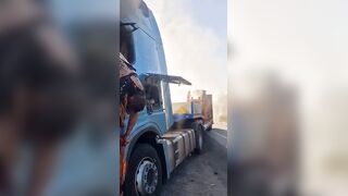 Dead corpse of pedoruzzian truck driver swaying from a cabin on occupied territories