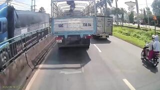 Woman Riding A Moped Falls Head First Under Truck Wheels