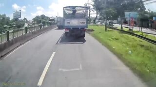 Woman Riding A Moped Falls Head First Under Truck Wheels