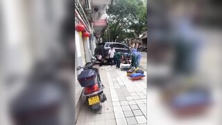 Rider Gets Crushed Against The Wall By Reversing SUV In China