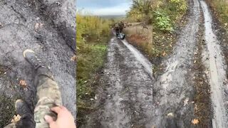 Two katsaps dragging a body of their dead comrade