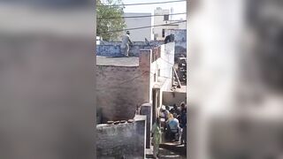 Man Throwing Sand During Celebration Falls From The Roof