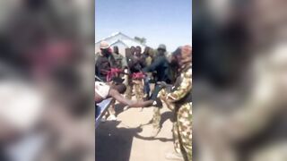 Nigerian Soldiers Having Fun With Killed Boko Haram Terrorist