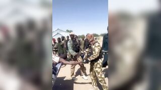 Nigerian Soldiers Having Fun With Killed Boko Haram Terrorist