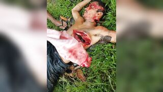 Mangled Man Convulses in Agonizing Pain, Covered in Machete Wounds and Filthy Mud