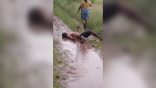 Mangled Man Convulses in Agonizing Pain, Covered in Machete Wounds and Filthy Mud