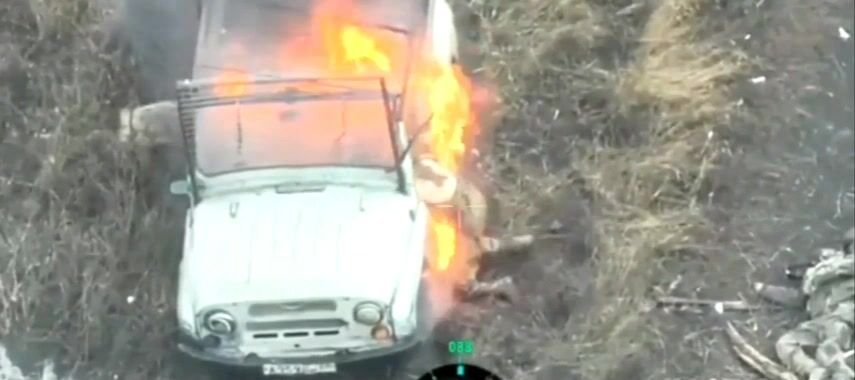 A russian invader got stuck in a burning vehicle