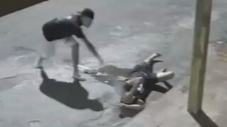 Drunk Man Lying On The Street Randomly Attacked With A Rock