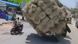 Terrifying Moment: Out-of-Control Tractor Loaded with Hay Flips onto Motorcyclist