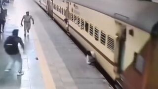 Man Leaps Onto Moving Train, Falls and Gets Dragged Spinning For Meters