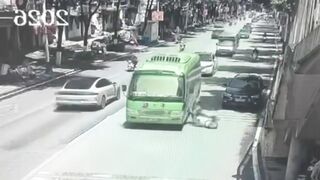 Woman Riding A Moped Falls Head First Under The Bus Wheel