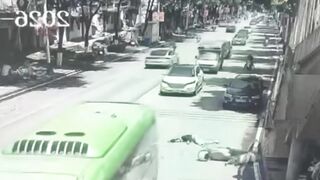 Woman Riding A Moped Falls Head First Under The Bus Wheel