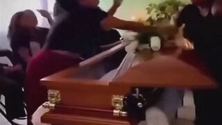 LoL "Widow argues with her husband's mistress at his coffin"