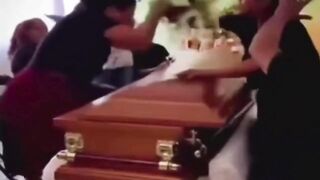 LoL "Widow argues with her husband's mistress at his coffin"
