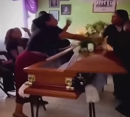 LoL "Widow argues with her husband's mistress at his coffin"