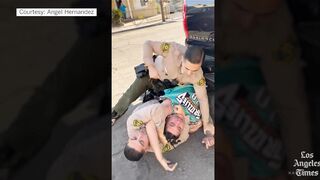 Los Angeles police officer abusing arrested man