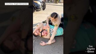 Los Angeles police officer abusing arrested man