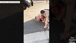 Los Angeles police officer abusing arrested man