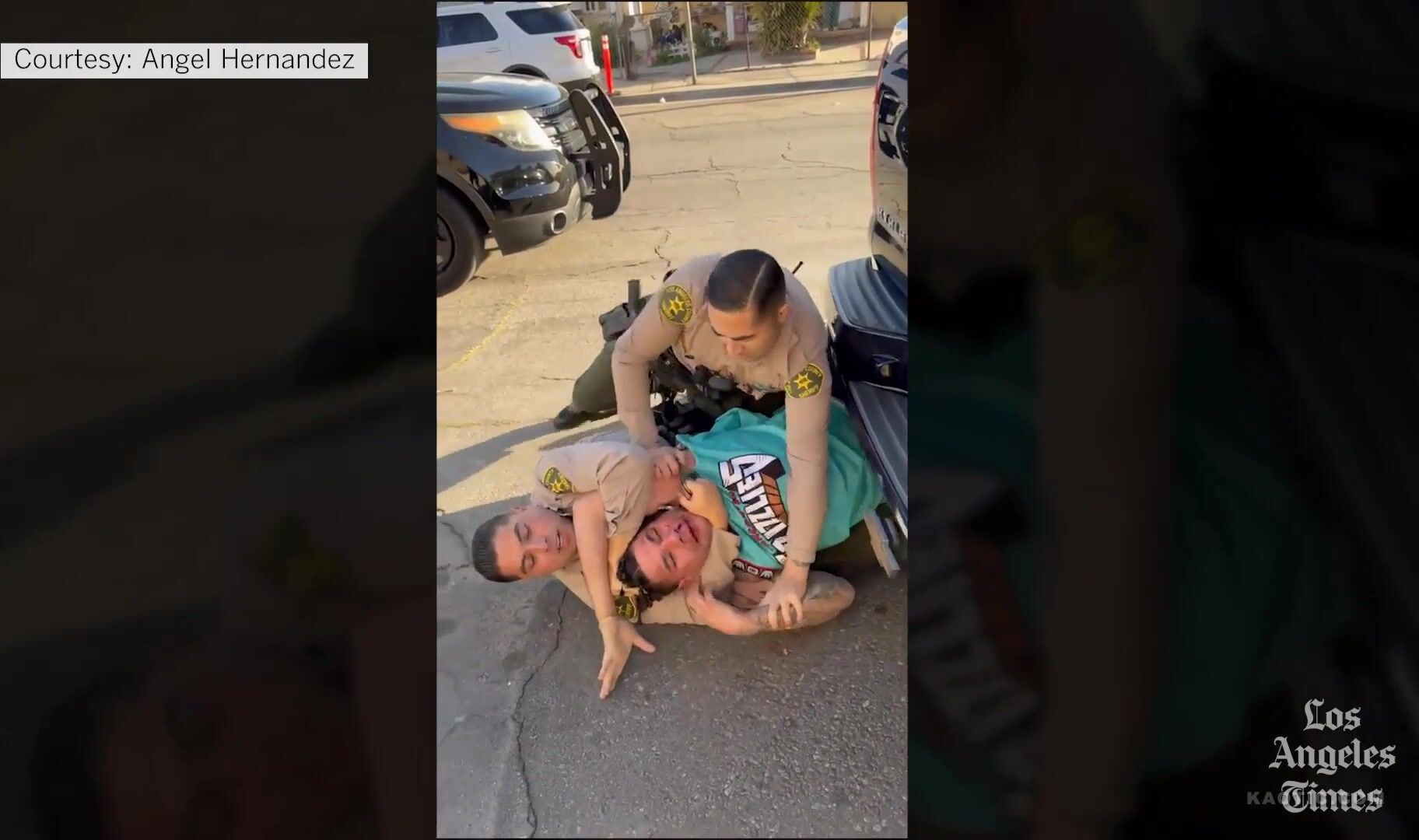 Los Angeles police officer abusing arrested man