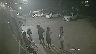 Hooded Hitman Ambush: Multiple Shots End Conversation on the Sidewalk