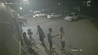 Hooded Hitman Ambush: Multiple Shots End Conversation on the Sidewalk