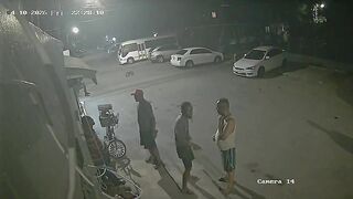 Hooded Hitman Ambush: Multiple Shots End Conversation on the Sidewalk
