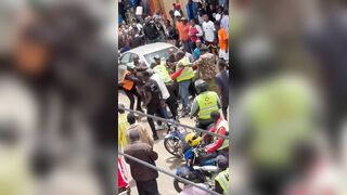 Phone Snatcher Attacked By Mob As Cop Tries To Shield Him