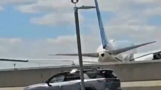 Plane landing gear hits roof of truck (2 Videos)