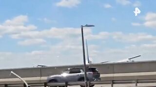 Plane landing gear hits roof of truck (2 Videos)