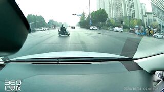 Motorcyclist flung into car trunk after high-speed crash at red light in China