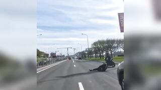 Biker falls, motorbike catches fire