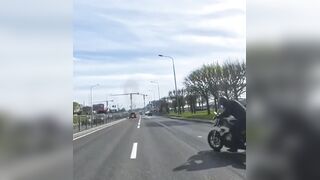 Biker falls, motorbike catches fire