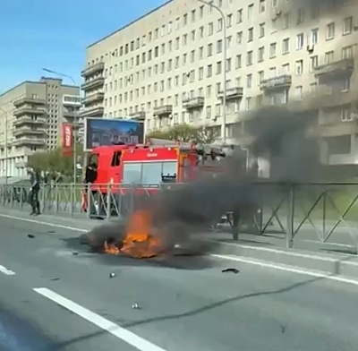 Biker falls, motorbike catches fire