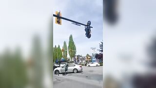 Motorcyclist Seriously Injured After Crash Leaves Bike Dangling From Traffic Light