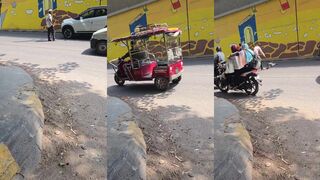 Indian old man sleeping on the street getting a motorcycle massage