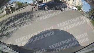 Car sends scooter teens flying close up in Kyiv Ukraine (Novi Petrovtsi)