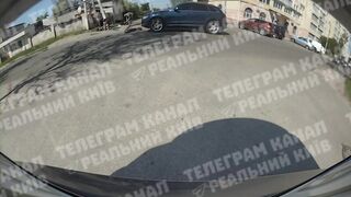 Car sends scooter teens flying close up in Kyiv Ukraine (Novi Petrovtsi)