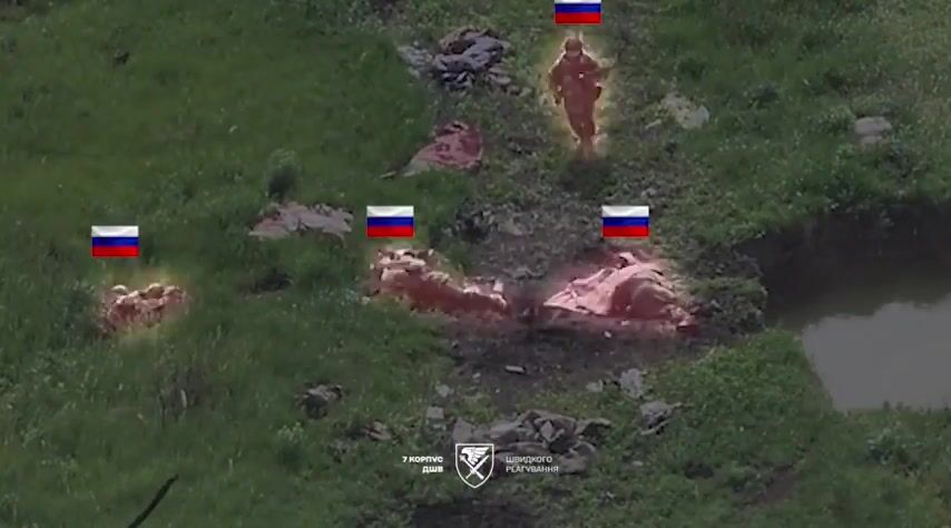 Russian invader running through road decorated with his comrade corpses