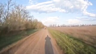 A Ukrainian drone strikes a moving vehicle carrying russian soldiers