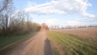 A Ukrainian drone strikes a moving vehicle carrying russian soldiers
